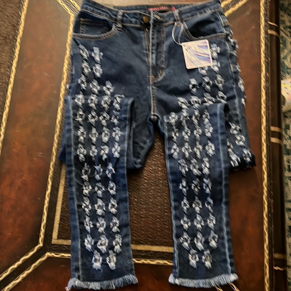 Denim jeans with holes all over